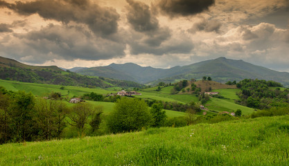 Fototapeta na wymiar Green hills. French countryside landscape in the Pyrenees mountains in Basque Country, France