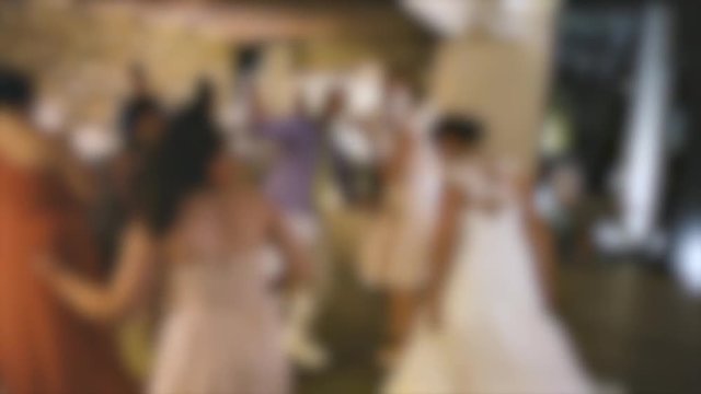Silhouette of dancing bride guests at modern causal wedding with funny atmosphere and joyful moments 