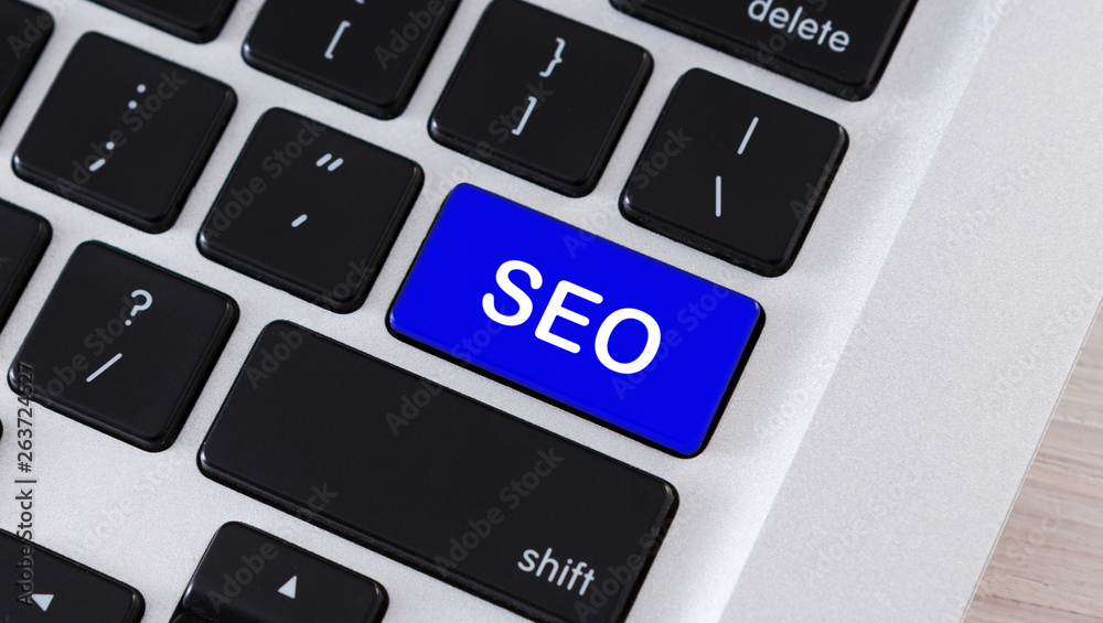 Poster SEO text on blue button of computer keyboard