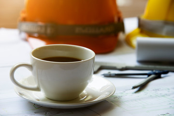 coffee cup with Architectural plans on blueprint with engineering tools inspection in workplace,...