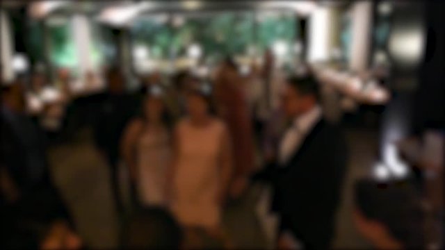 Silhouettes of dancing group of people and bride guests at modern causal wedding with funny atmosphere and joyful moments 