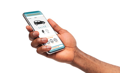 Black man using car rent application on mobile phone