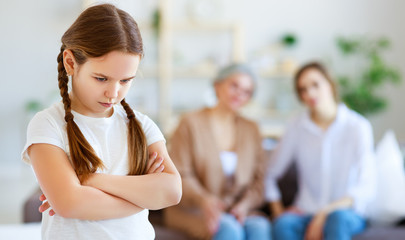 conflict of family three generations angry mother and grandmother scolding  naughty child.