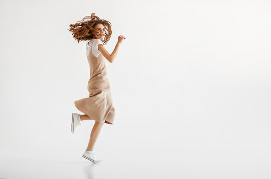 happy young woman jumping on white background
