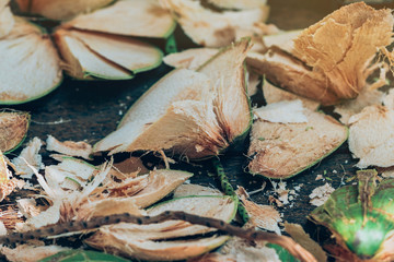 Close up to Coconut peel on the table after being peeled to make coconut juice.