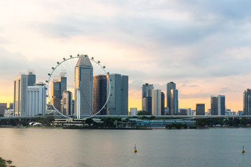 Fototapeta na wymiar Singapore flyer cityscape on marina bay and sunset in twilight time . Taken photo from marina barrage .