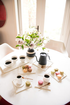 coffee with macaroons at the table for breakfast