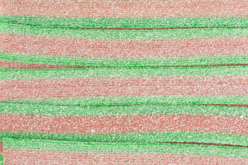 striped gummy candy in green and red with melon flavor