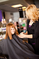 Happy Red-Haired Girl Getting Haircut in Hair Salon