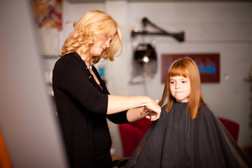 Red-Haired Girl Getting Haircut in Hair Salon