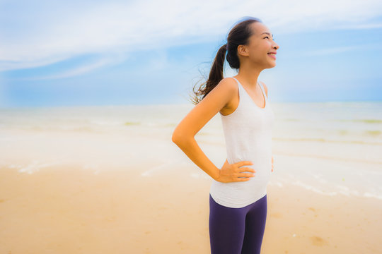 Portrait beautiful young sport asian woman exercise by run and jogging on the outdoor nature beach and sea