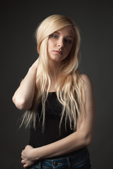 Naklejka premium Attractive blonde girl on gray background