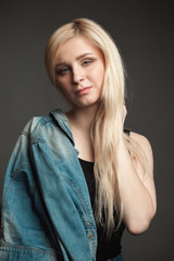 Attractive girl in denim jacket with beautiful blonde hair