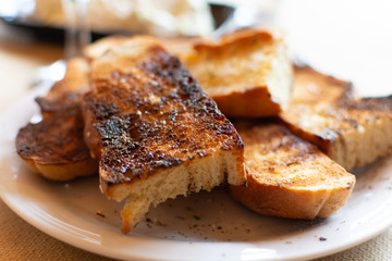 Greek food, roasted bread with olive oil, red wine and tzatziki sauce