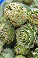 Bunch of fresh raw artichokes heads from artichoke plantation in Argolida, Greece on argicultural market in Nafplio