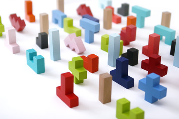 Wooden colored 3D geometric shapes arranged chaotic on a white background. Cover background template for the presentation, brochure, web, banner, catalog, poster, book, magazine