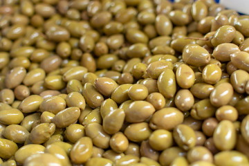 Traditional greek food ingredient, green olives in box on farmer market