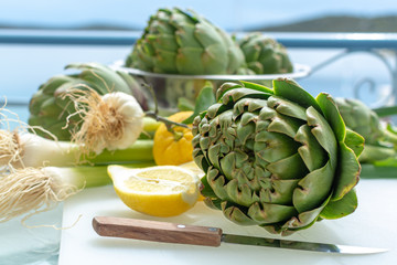 Heads flowers of fresh raw artichokes plants from artichoke plantation in Argolida, Greece ready to...