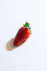 Fresh strawberry berries on a white background. Vertical orientation