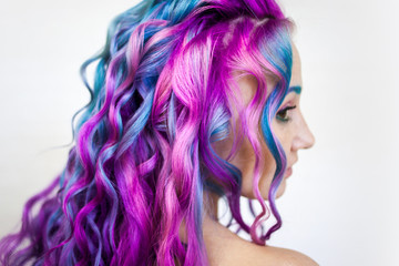 Bright multi-colored hair coloring, gradient blue purple and pink shades. Beautiful hair