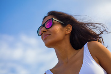 Young indian woman looking aside on the beach