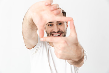 Fototapeta premium Handsome cheerful man wearing blank t-shirt