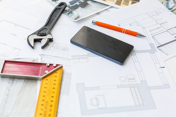 Architect design working drawing sketch plans blueprints and smart phone on architectural project...