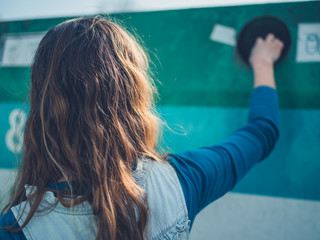 Young woman recycling glass bottle