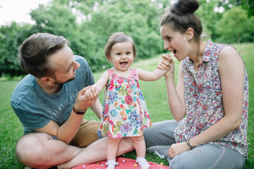 Family spending time together and laughing together at a picnic