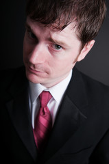Young Businessman in Suit on Black Background