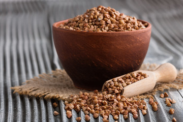 Grain buckwheat on a gray wooden background