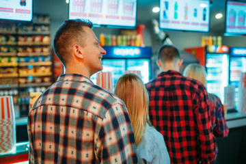 Audience choosing food in cinema bar