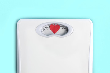 Floor scales with hearts instead of numbers. Love your body concept. Lifestyle motivation. Light blue background
