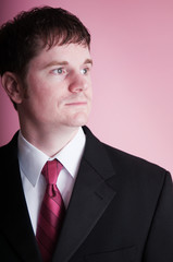 Young Businessman in Suit on Pink Background