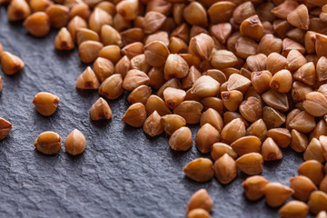 Grain buckwheat on a dark stone background
