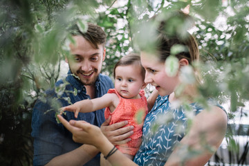 Family enjoy a moment together looking at leaves
