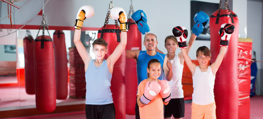 Teenagers posing in fighting stance at boxing gym