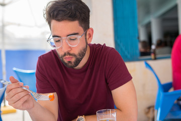 young man eating in the restaurant