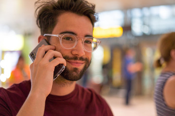 young man talking mobile phone in the airport