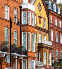 Luxury brick house with white windows in quiet area in central London. Apartments on the banks of the Thames.