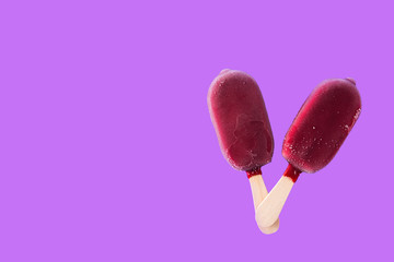 Strawberry popsicle on violet background. Top view. Copyspace