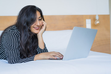 young indian woman using the laptop