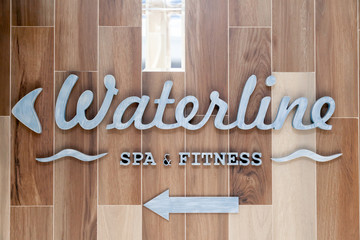 Silver letters, pointer of waterline, spa, fitness sign on the wall hotel, lobby. Concept sign,...