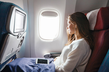 Teenage girl travelling by airplane