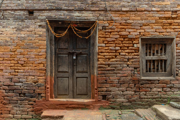 Fototapeta na wymiar Old plain newari style door and window