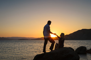 Silhouette couple in love on summer holiday