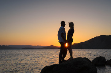 Romantic couple on sunset background