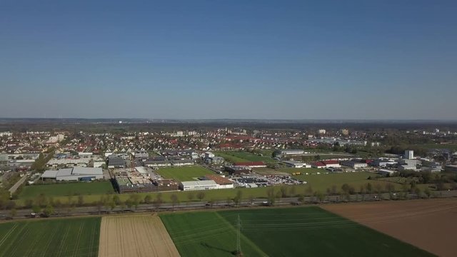 Aerial drone footage of Haunstetten, a suburb of Augsburg in Germany. View over the federal Highway B17 towards the commercial and industrial district of Haunstetten.