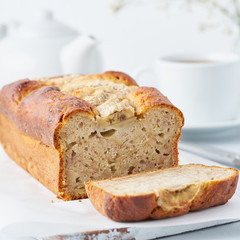 Banana bread, slice of cake with banana, side view, close up. The morning Breakfast on a light grey background
