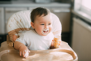baby in the kitchen eagerly eating the delicious cream horns, filled with a vanilla cream